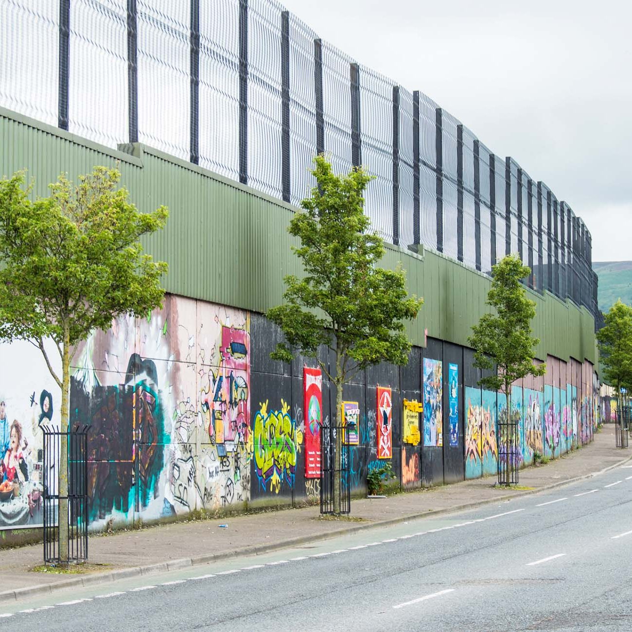 Belfast murals. Political mural in Belfast, Northern Ireland. Falls Road and Shankill Road are famous for their political murals. This wall divide the part catholic and that protestant